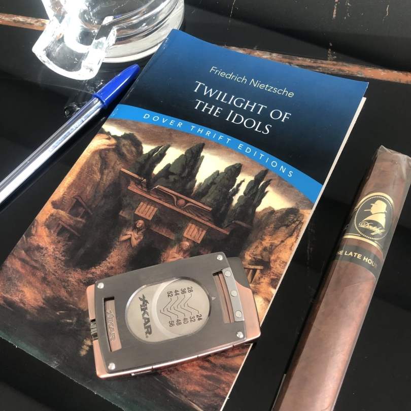 Reading Friedrich Nietzsche's Twilight of the Idol and Smoking a Cigar