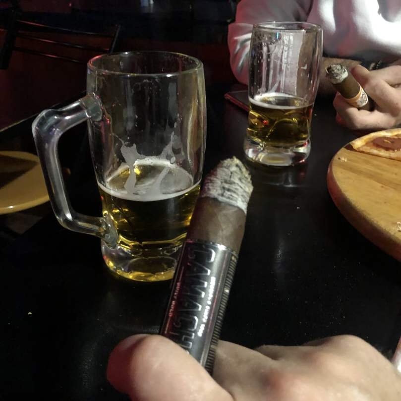 Cigar and beer with a friend at a bar