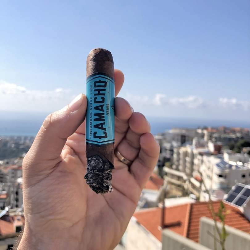 Chris Khatschadourian smoking a Camacho Ecuador Robusto on the terrace.